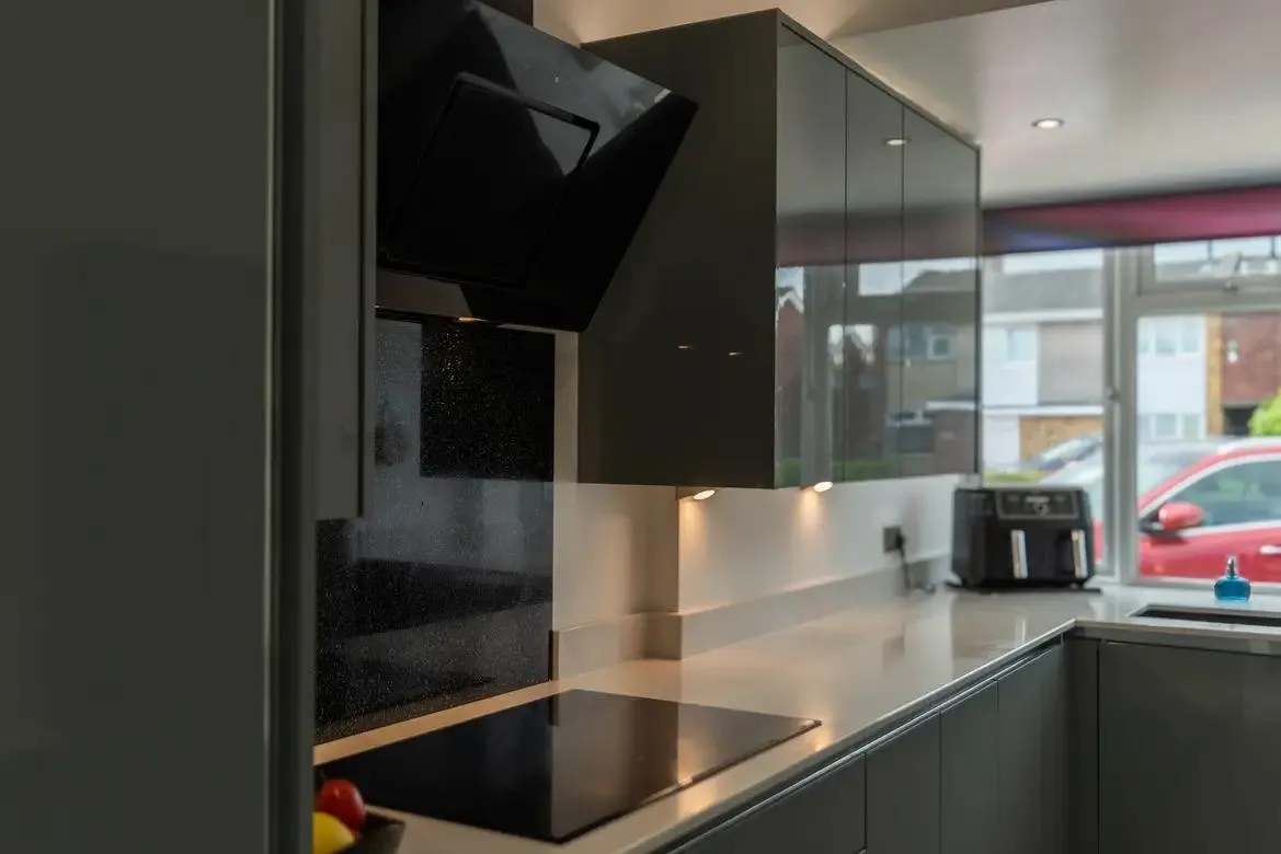 a kitchen with a stove top oven sitting next to a window