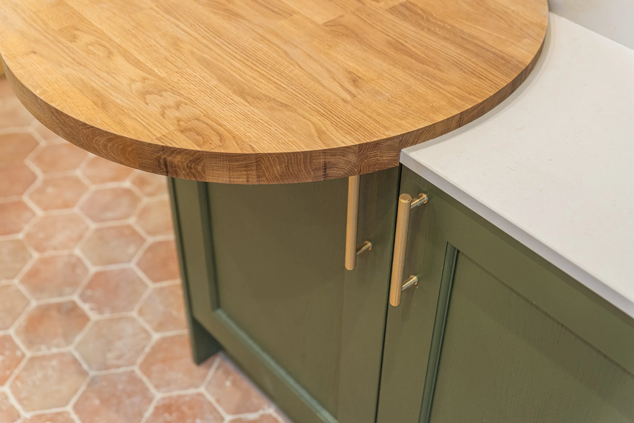 A wooden counter top sitting on top of a green cabinet.