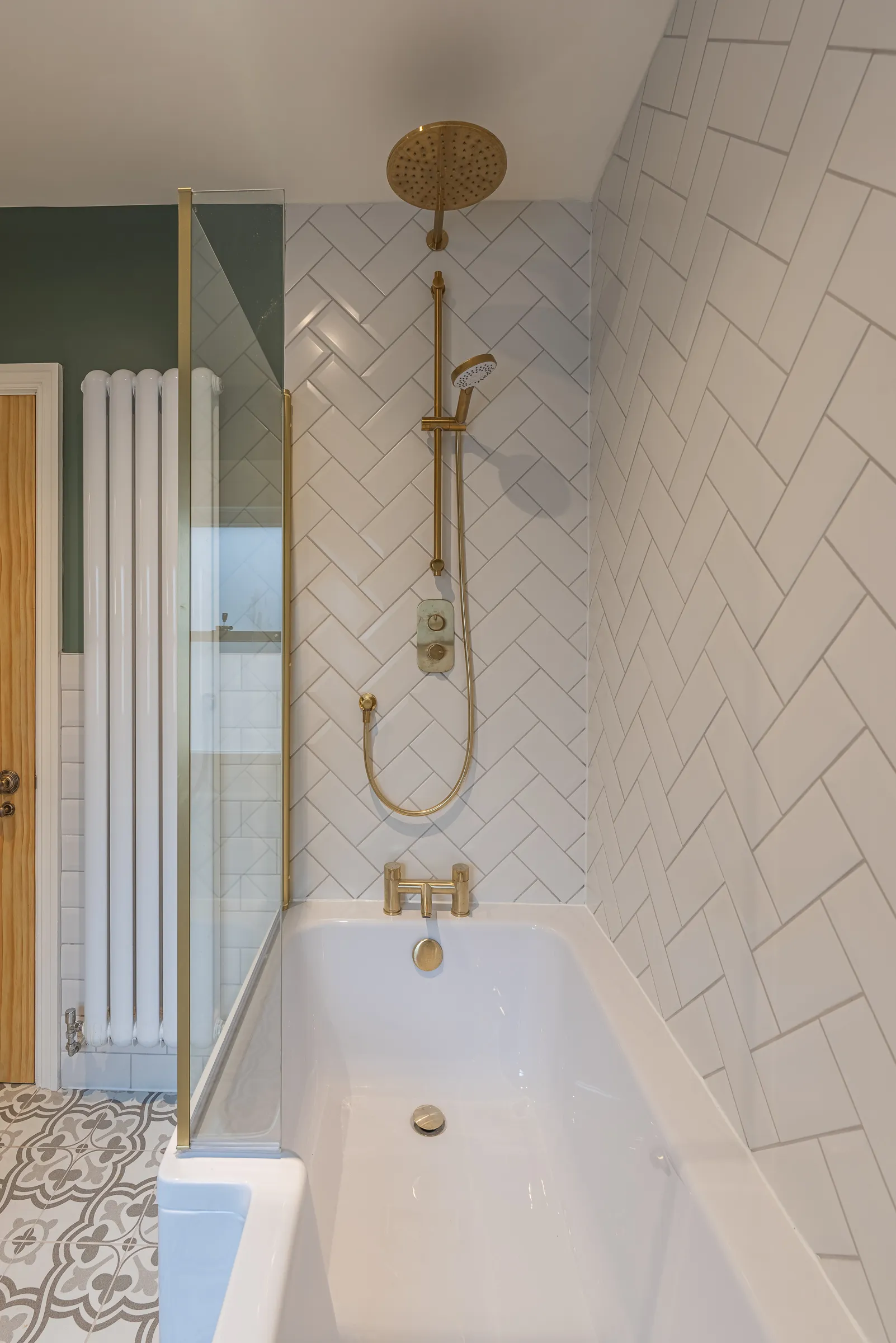 A white bath tub sitting next to a wooden door.