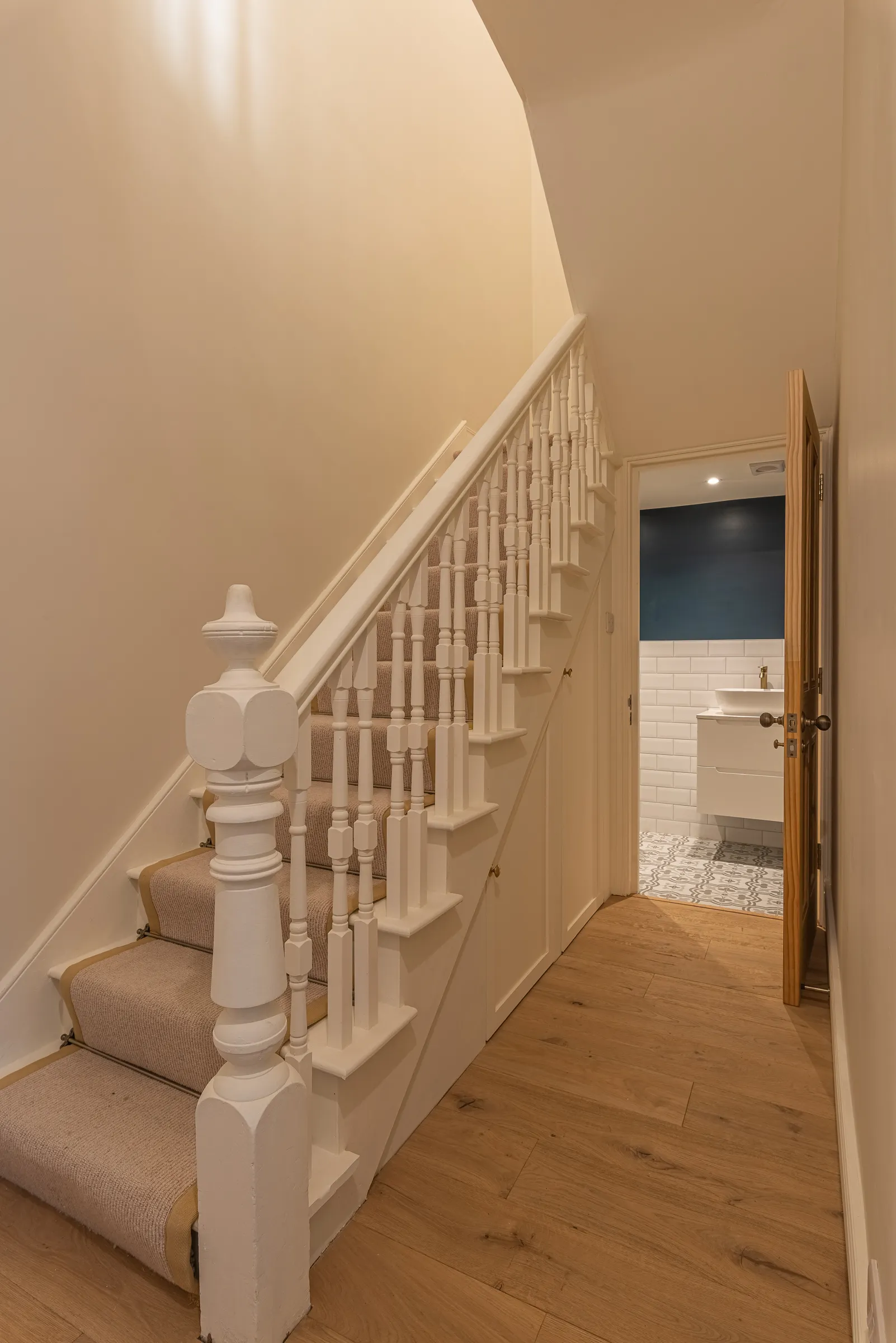 A staircase leading to a bathroom in a house.
