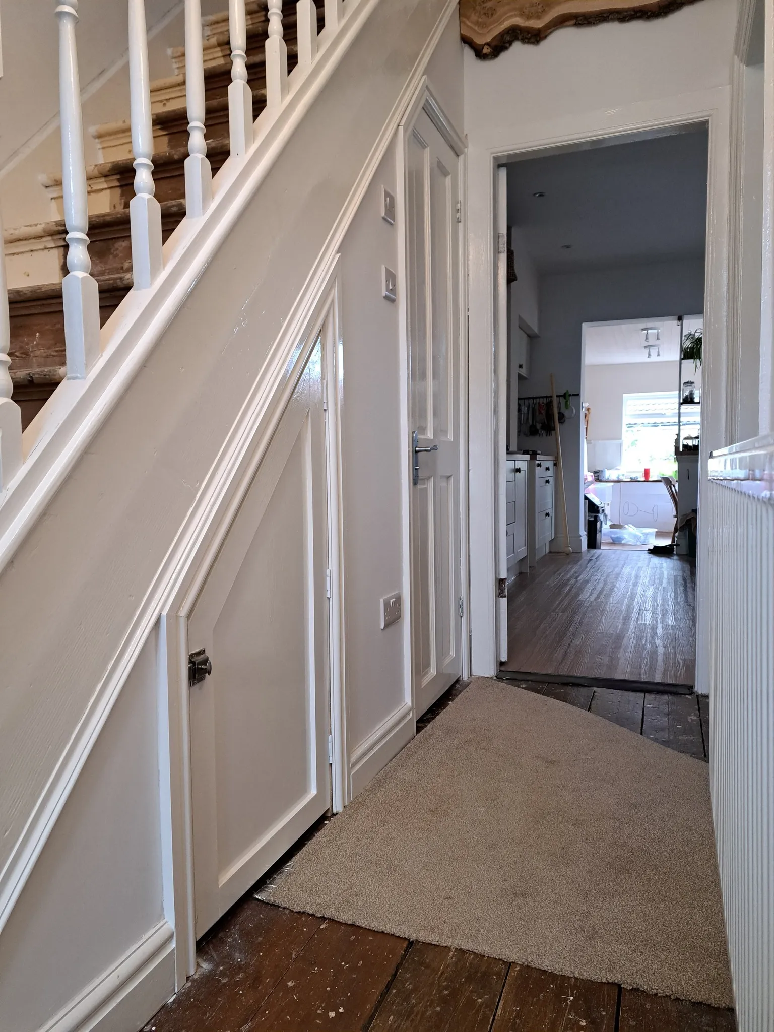 A staircase leading to a bedroom and a living room.