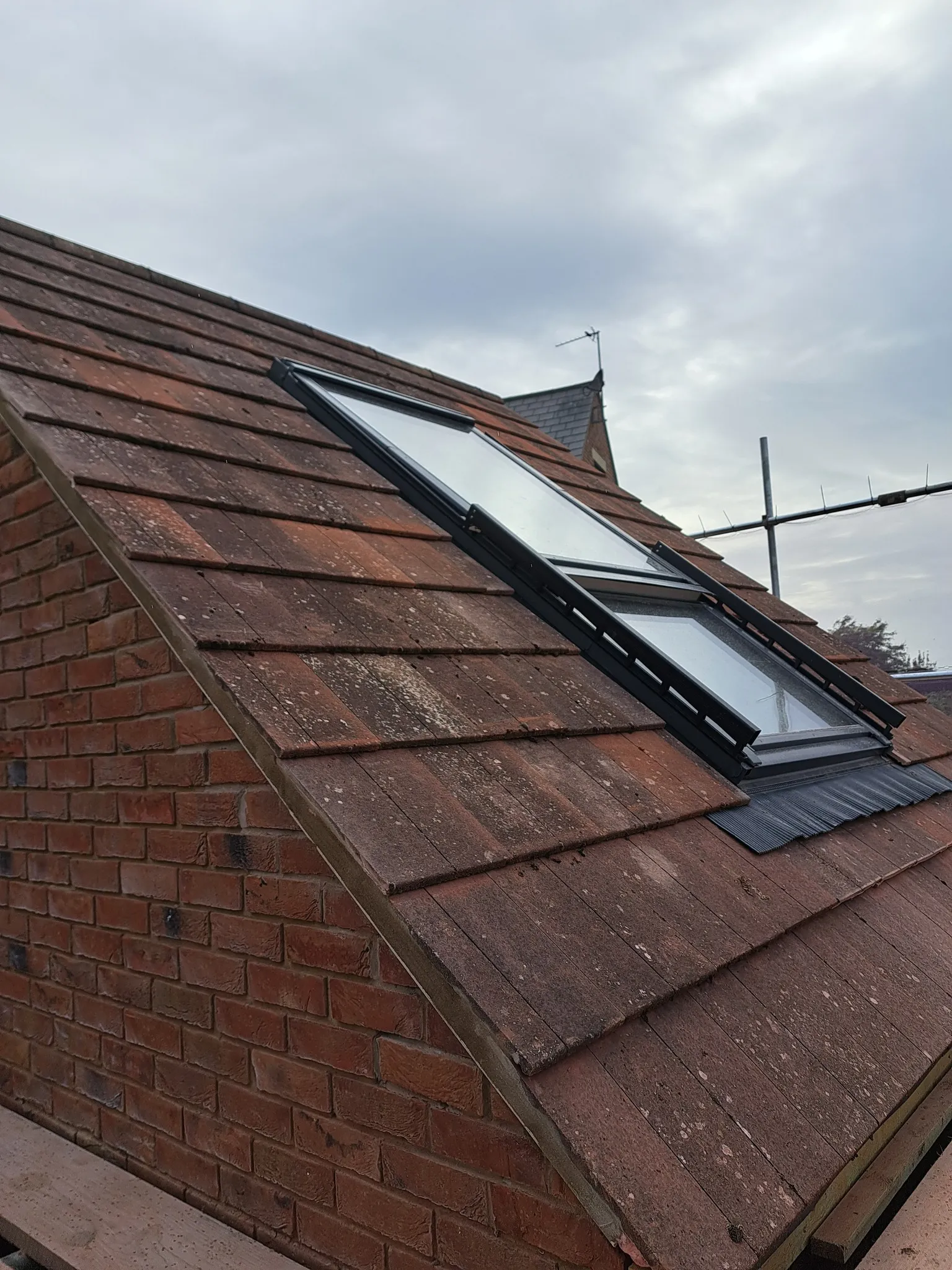 A brick building with a skylight on top of it.