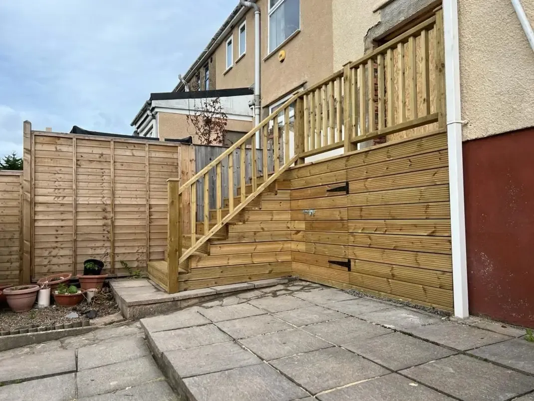 A wooden staircase next to a building.